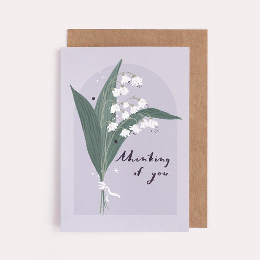 A sympathy card featuring illustrated Lily of the Valley that says "thinking of you"