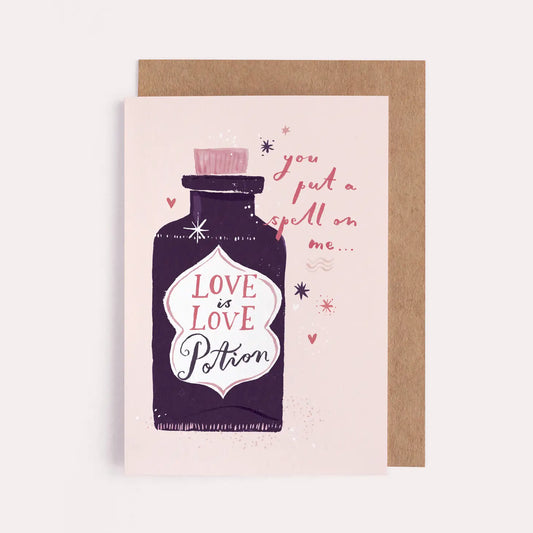 A greeting card with an illustration of a bottle that reads "Love is Love Potion"