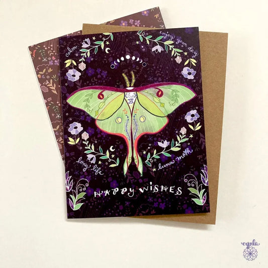 Illustration of a luna moth on a greeting card that says "Happy Wishes"