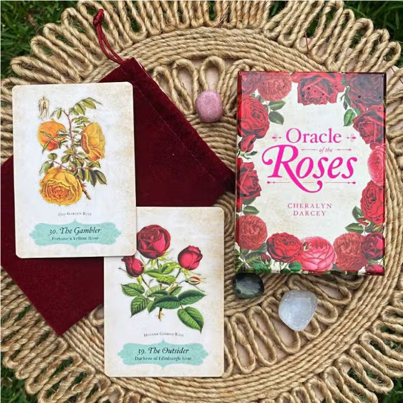 The Oracle of Roses deck displayed on a rattan mat with 2 cards and crystals