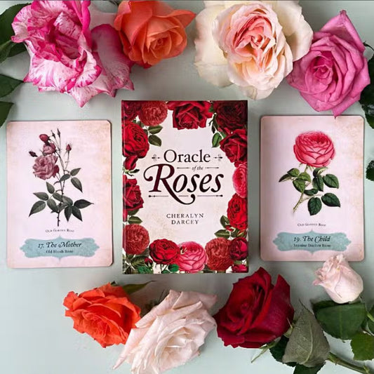 The Oracle of the Roses Deck displayed with two cards and some actual roses