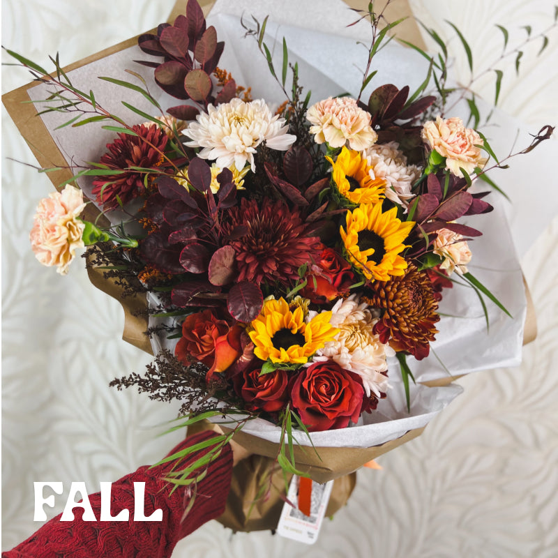 A large autumn flower bouquet with text that reads "Fall"