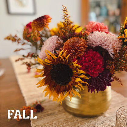 Deluxe seasonal fall vase arrangement displayed on a dining table