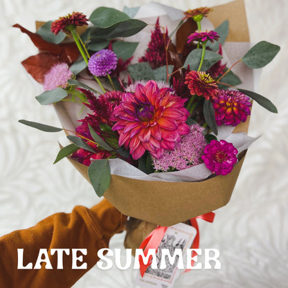 Wrapped seasonal flower bouquet featuring late summer favorites like Dahlias and Zinnias
