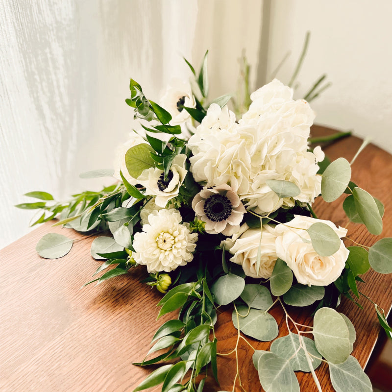 Small bouquet of premium white flowers laying on its side