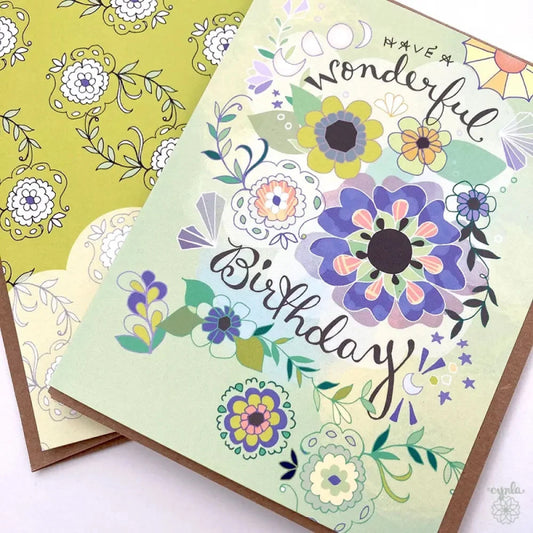 Greeting card with illustration of flowers, moons, and crystals that says "Have a Wonderful Birthday"